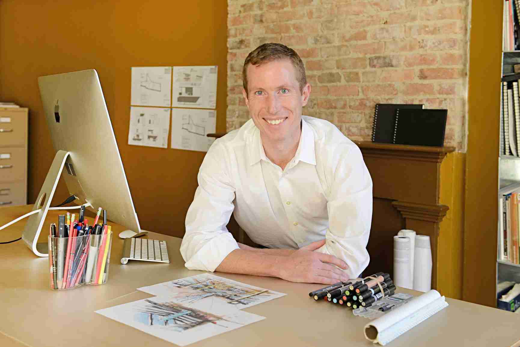 Eric Davenport, AIA, NCARB — founder and principal of LEAP Architecture, at his drafting desk